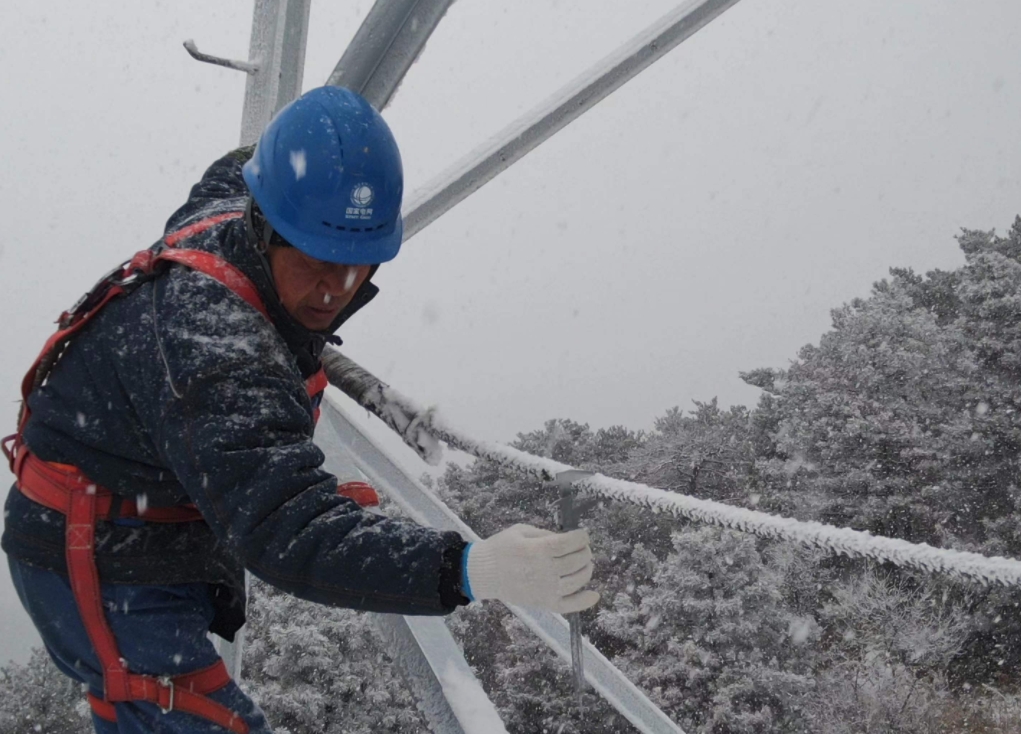 2月20日，國網晉城供電公司輸電運檢中心員工在220千伏尖坪線18號模擬導線進行覆冰取樣檢測。張浩然攝